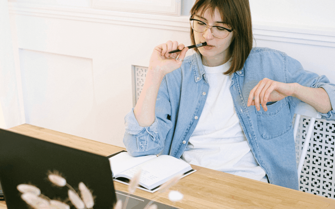 person working on laptop pausing because of Adult ADHD Symptoms