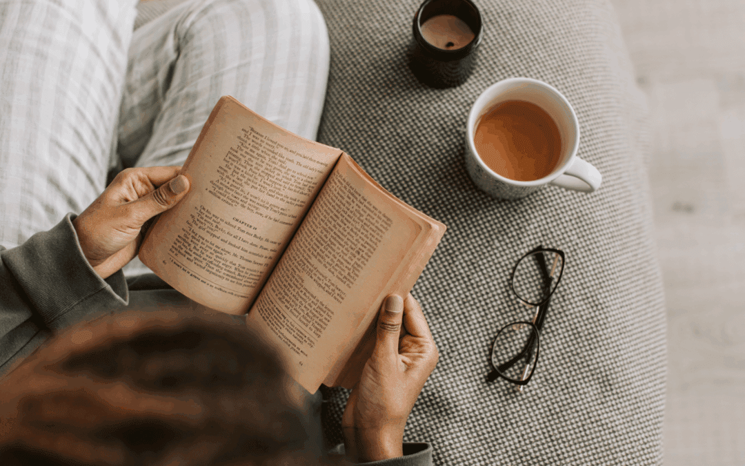 person cozied up with a book and coffee
